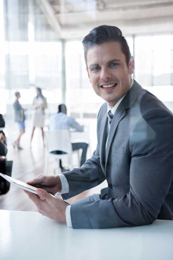 Confident professional reviewing business data on a tablet in a modern office, offering expert business financial consultant Fort Lauderdale services