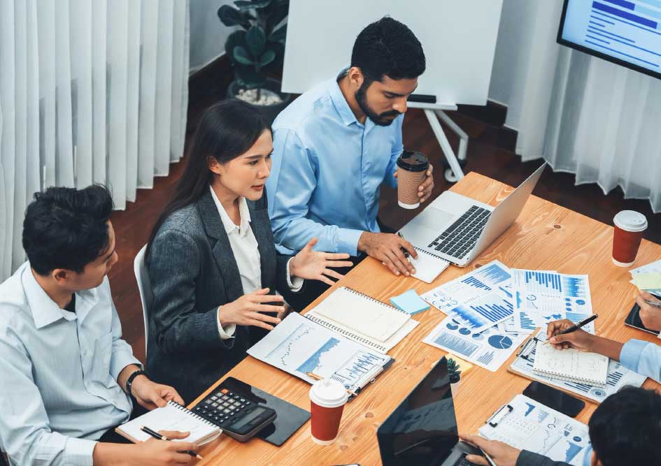 cpa-pompano-beach-4 Team of professionals discussing financial reports around a conference table, showcasing collaborative cpa pompano beach accounting services
