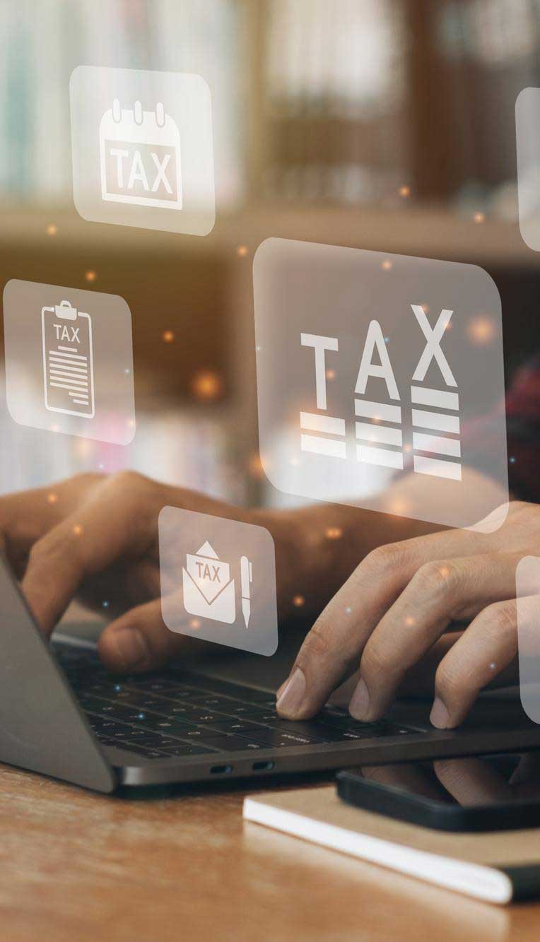 Person typing on a laptop with digital TAX icons, calendar, documents, and financial symbols floating above the keyboard, representing online tax filing and financial management services, Tax Preparation Miami